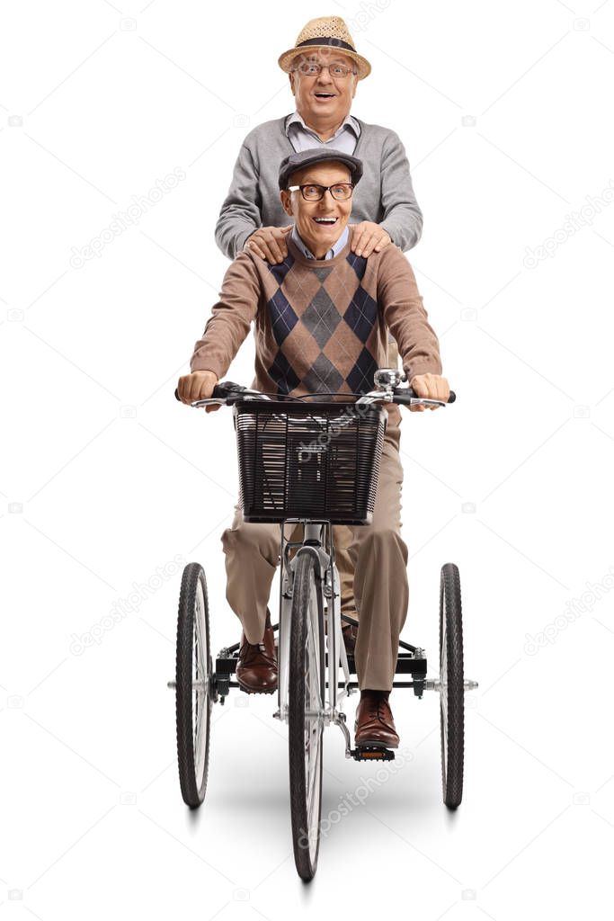 Senior riding a tricycle and man standing behind