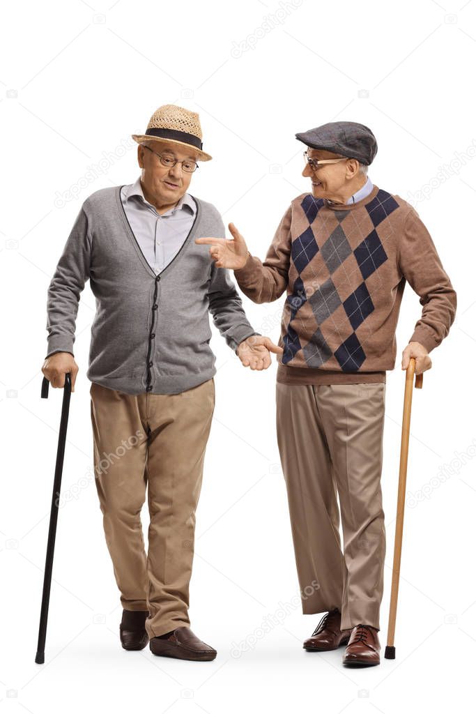 Two senior men with walking canes talking