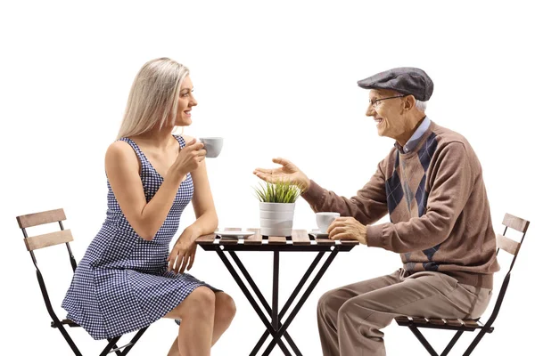 Elderly man and young woman drinking coffee — Stock Photo, Image