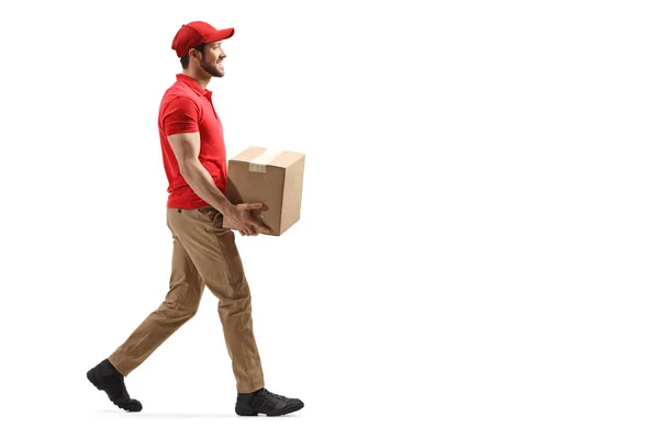Delivery man carrying a package and walking — Stock fotografie