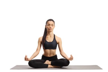 Young female practicing meditation on an exercise mat