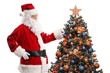 Santa Claus looking at a Christmas tree 