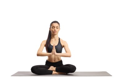 Young female practicing meditation with closed eyes 
