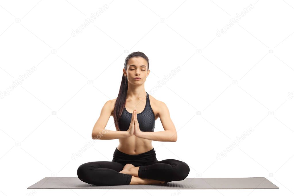 Young female practicing meditation with closed eyes 