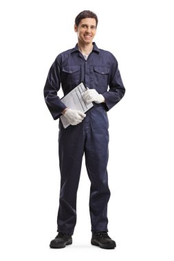 Full length portrait of a young guy in a working uniform holding a clipboard isolated on white background clipart
