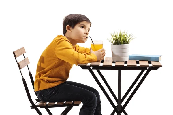 Pensive Boy Drinking Juice Table Looking Away Isolated White Background — Stock Photo, Image
