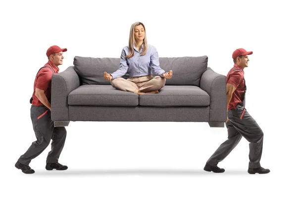 Young Woman Meditating Sofa Two Male Workers Carrying Sofa Isolated — Stock Photo, Image