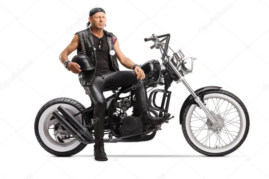 Biker holding a helmet and sitting on a custom chopper isolated on white background