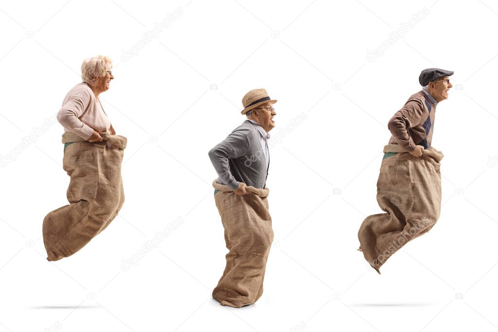 Senior people playing gunny race and jumping in a sack isolated on white background