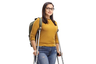 Female student standing with crutches isolated on white background clipart