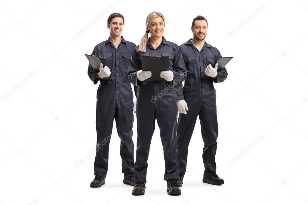 Full length portrait of one female and two male workers in overall uniforms isolated on white background