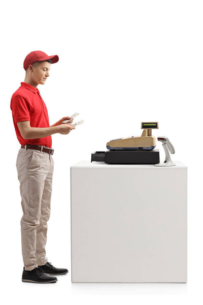 Full length profile shot of a cashier counting money isolated on white background