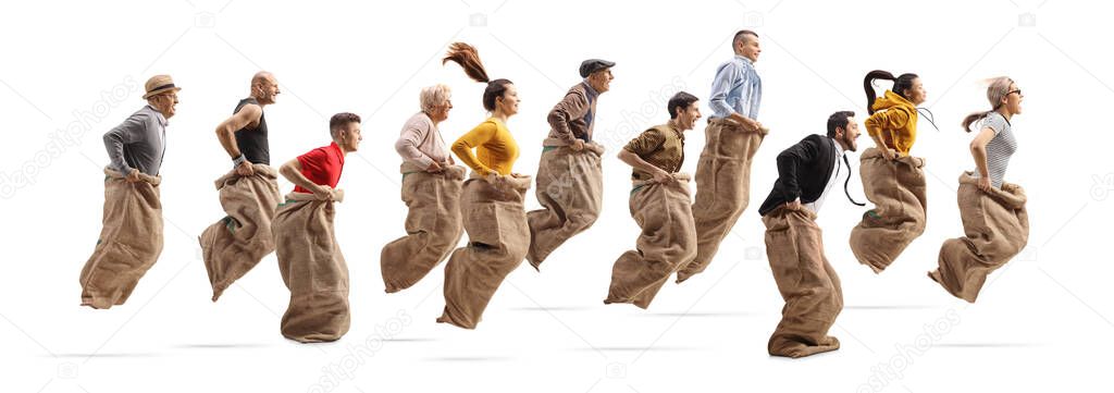 Profile shot of many people playing a gunny race and jumping with sacks isolated on white background