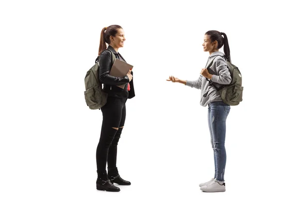 白地に隔離された会話を持っている2人の女性学生の完全な長さのプロフィール写真 — ストック写真