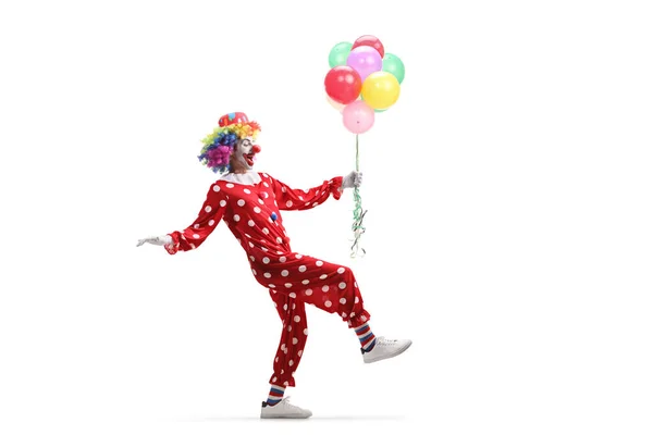 Vollständige Profilaufnahme Eines Clowns Der Vorsichtig Mit Einem Bündel Luftballons — Stockfoto