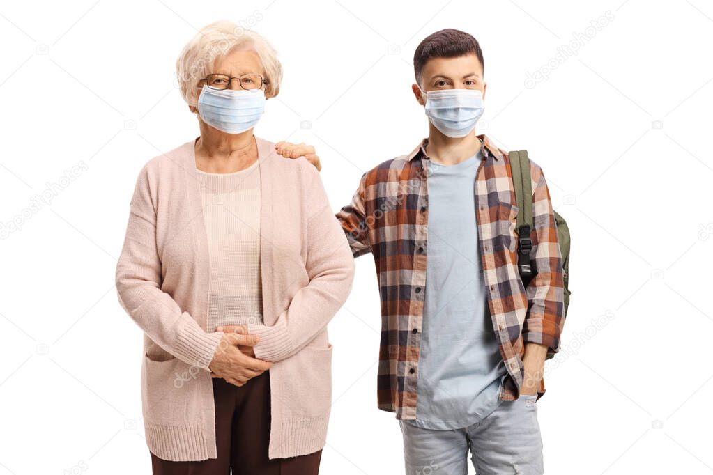 Grandmother and teenage grandson with protective face masks isolated on white background