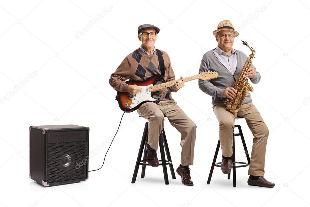 Elderly men sitting on chairs with an electric guitar and a sax isolated on white background