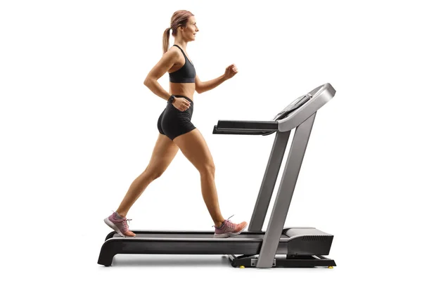 Full Length Profile Shot Muscular Young Woman Running Treadmill Isolated — Zdjęcie stockowe