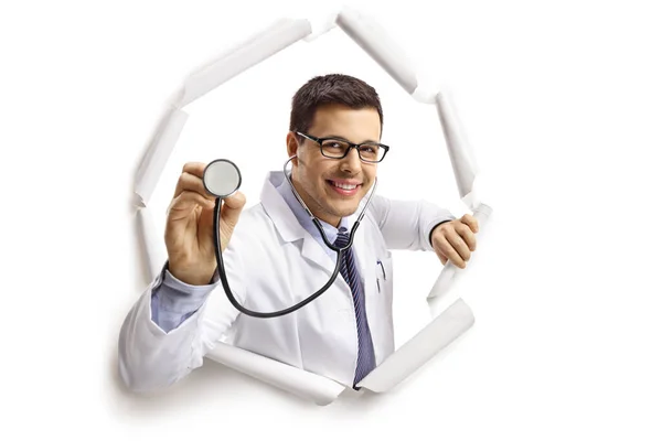 Cheerful Young Male Doctor Stethoscope Looking Paper Hole Isolated White — Stock Photo, Image