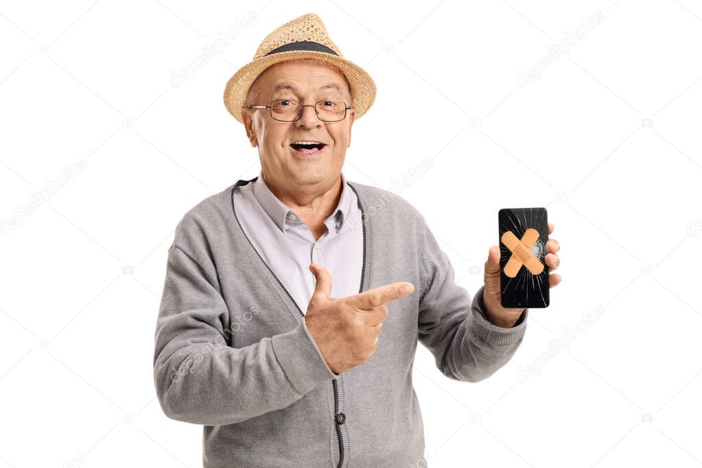 Elderly man holding a mobile phone with plasters on the broken screen isolated on white background
