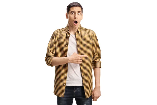 Shocked young man pointing to the side isolated on white background