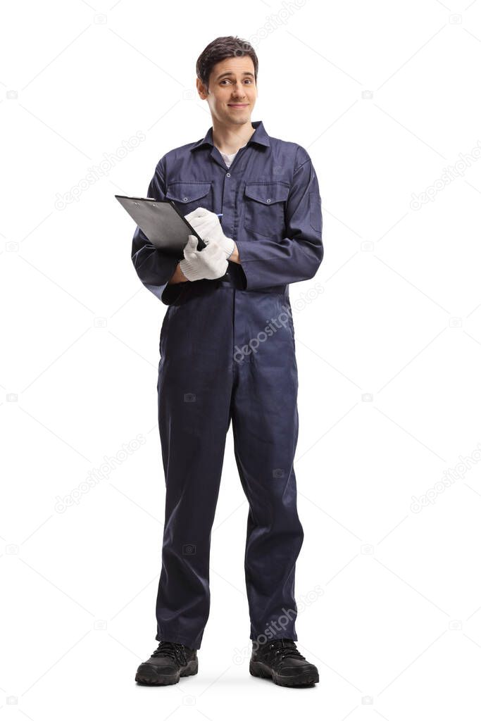 Full length portrait of a male worker in a uniform holding a clipboard isolated on white background