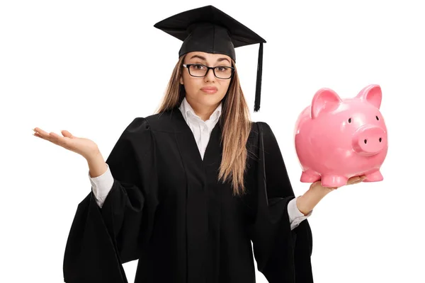 Confused Female Graduate Holding Piggy Bank Isolated White Background — Stock Photo, Image