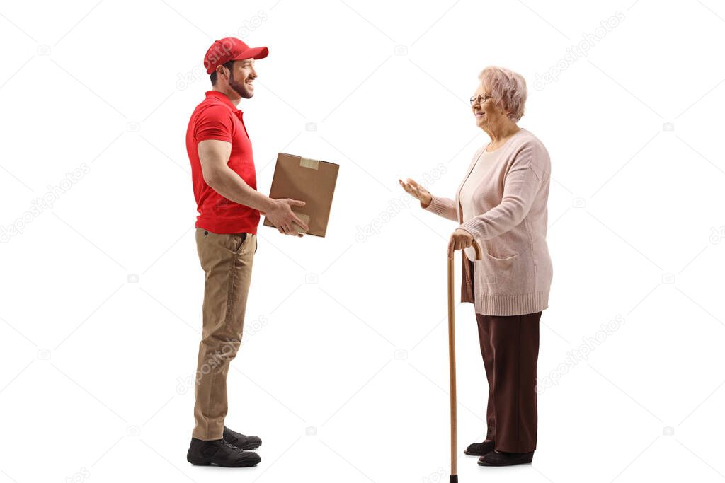 Full length portrait of a delivery man giving a package to a senior woman isolated on white background