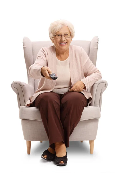 坐在扶手椅上 手持电视遥控器 白色背景隔离的一位老妇人的全长肖像 — 图库照片