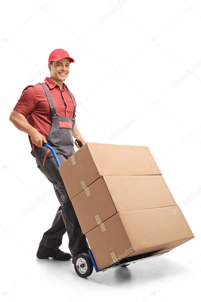 Male worker pushing a hand truck loaded with boxes isolated on white background