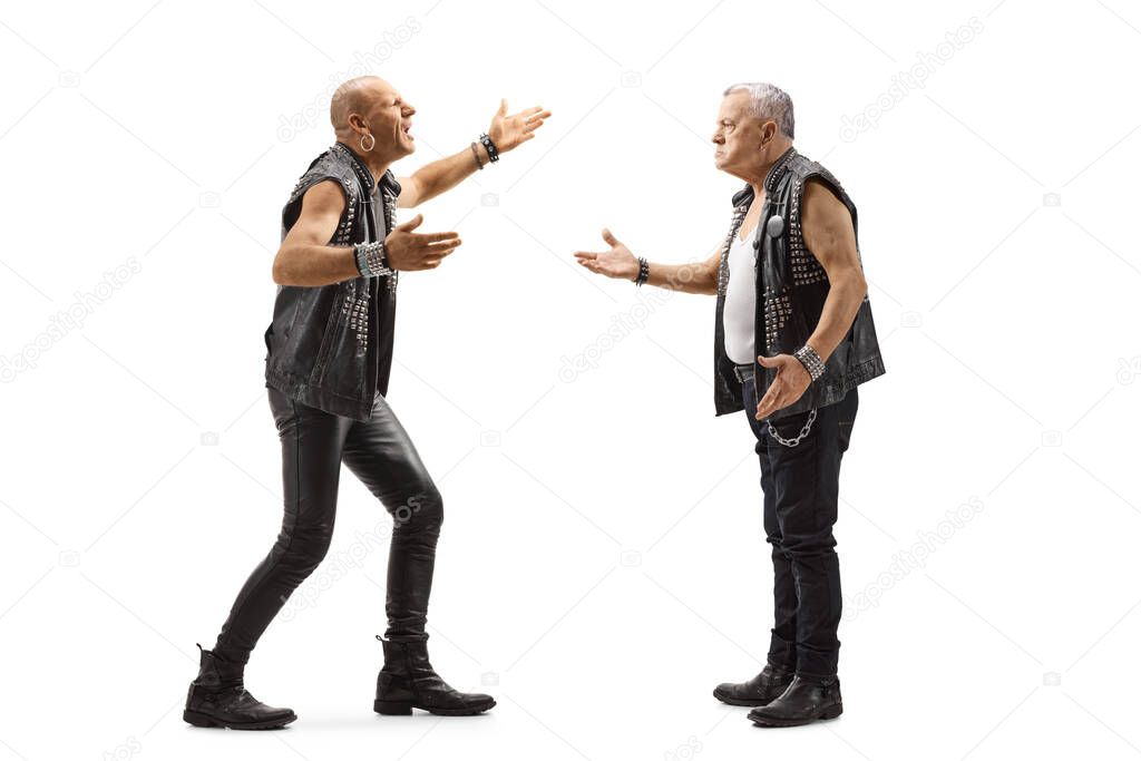 Full length profile shot of two angry punk men having an argument isolated on white background