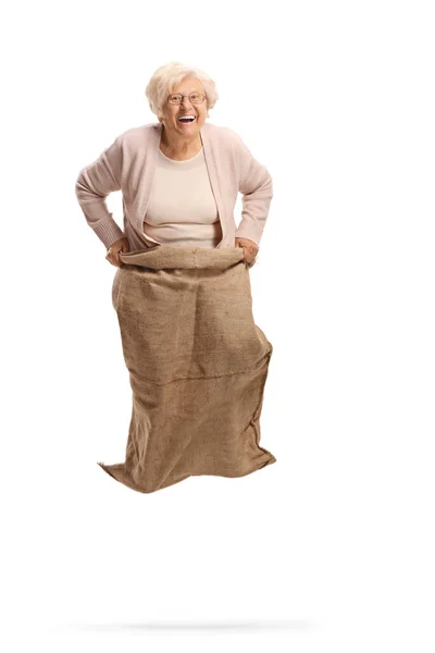 Gelukkig Bejaarde Vrouw Springen Met Een Zak Lachen Geïsoleerd Witte — Stockfoto