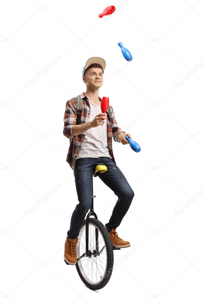 Young male student juggling on a unicycle isolated on white background