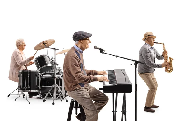 Senior people playing drums, keyboard and a saxophone in a music band isolated on white background