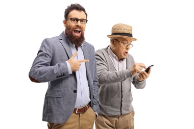 Sakallı adam gülüyor ve beyaz arka planda izole edilmiş bir cep telefonu kullanan yaşlı bir adamı işaret ediyor.