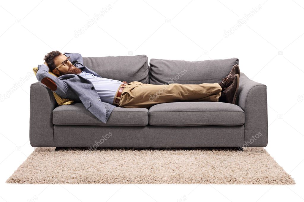 Bearded man resting on a couch after work isolated on white background