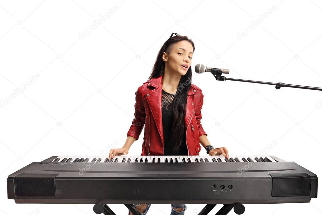 Female playing a keyboard and singing on a microphone isolated on white background