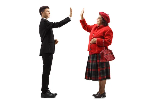 Full Length Profile Shot Young Man Gesturing High Five Elderly — Stock Photo, Image