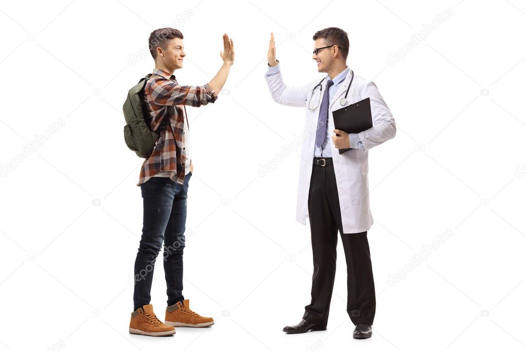 Full length shot of a male student and a male doctor gesturing high-five isolated on white background
