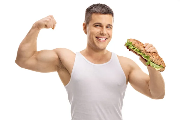 Sterke Man Toont Biceps Spier Het Eten Van Een Sandwich — Stockfoto