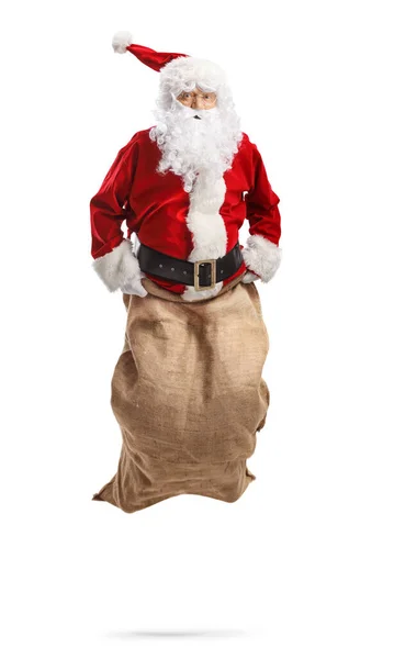 圣诞老人跳进了一个用白色背包隔开的袋子里 — 图库照片