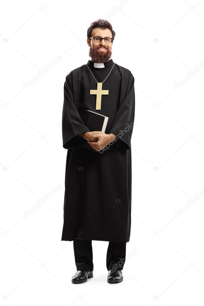 Full length portrait of a priest standing and holding the Bible isolated on white background