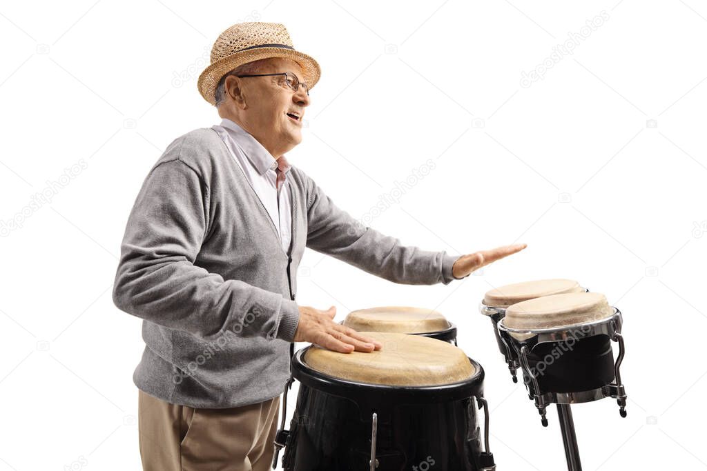 Elderly man playing conga drums isolated on white background