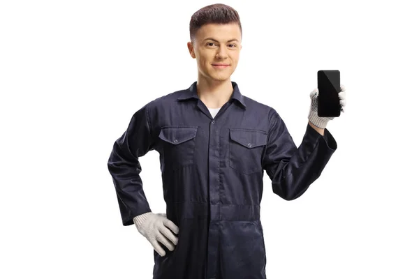 Young Mechanic Holding Mobile Phone Pointing Isolated White Background — Stock Photo, Image