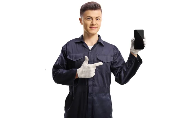 Young Mechanic Holding Mobile Phone Pointing Isolated White Background — Stock Photo, Image