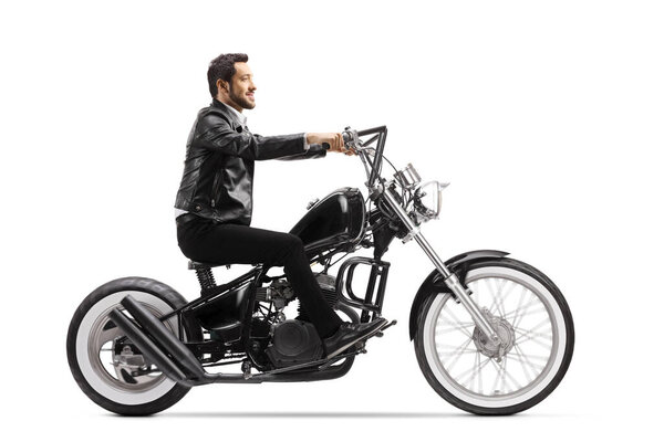 Young man in leather jacket riding a chopper motorbike isolated on white background