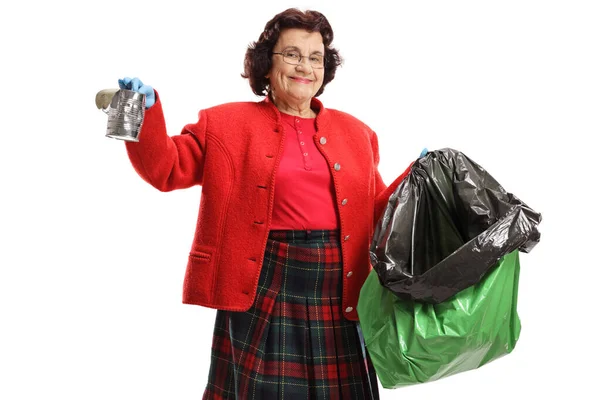 Mujer Mayor Recogiendo Una Lata Una Bolsa Plástico Aislada Sobre —  Fotos de Stock