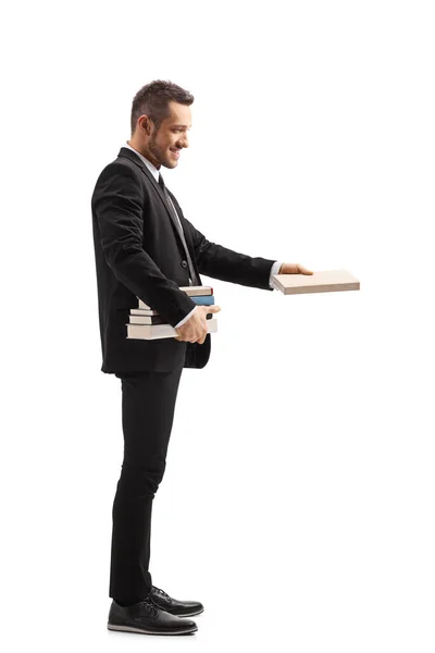 Full Length Profile Shot Man Black Suit Holding Pile Books — Stock Photo, Image