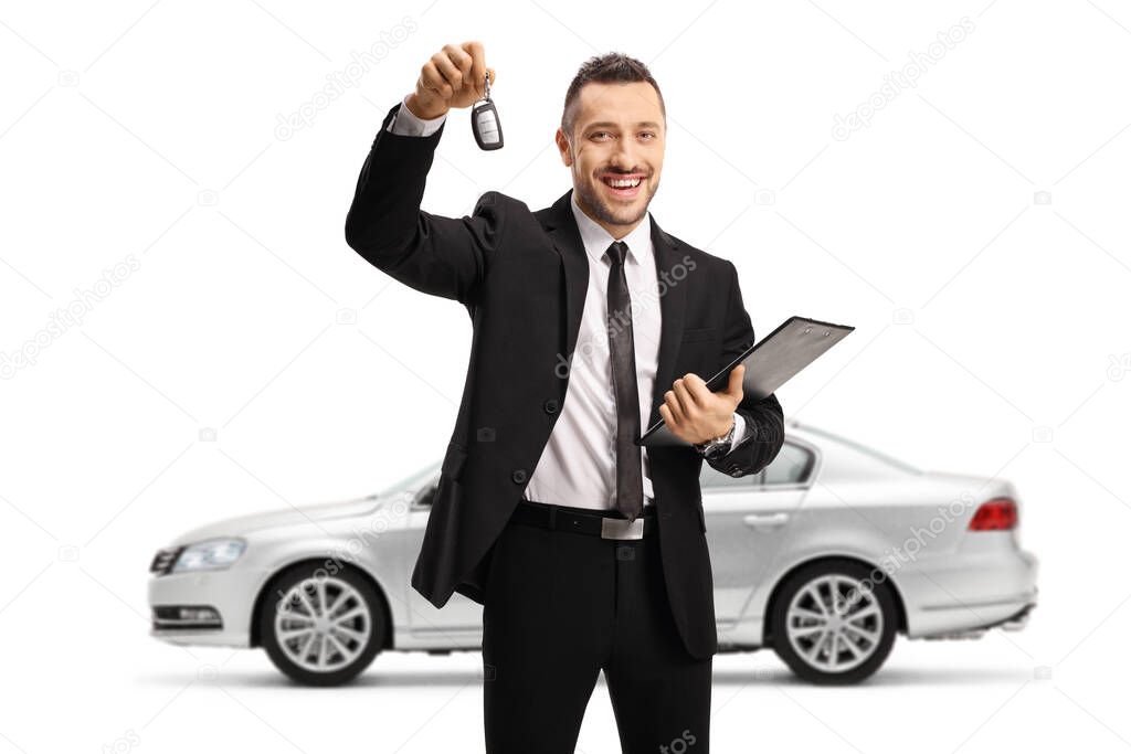 Man holding car keys from a silver car and a folder with a document isolated on white background