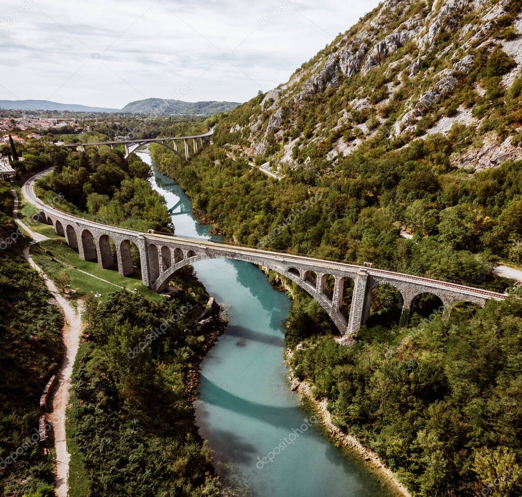 The Solkan Bridge is the longest stone bridge. The bridge connects Slovenia and Italy. Railway bridge in the mountains across the blue river Soca. Located in the west of Slovenia.